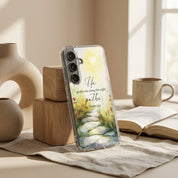 Samsung phone case with nature design and text on a table with decor items