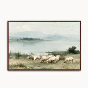 Framed vintage oil painting of sheep grazing beside still waters under rolling hills, featuring Psalm 23 scripture text "He leads me beside still waters".