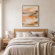 Framed abstract sunrise canvas wall art hanging above a light wood bed in a serene Scandinavian minimalist bedroom.