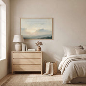 Framed vintage Lamentations 3:22-23 Christian landscape canvas wall art featuring a soft sunrise scene hanging on a textured beige wall above a light wood dresser nightstand and neutral linen bed in a soft organic modern bedroom.
