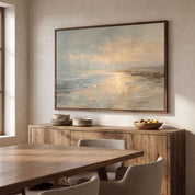 Framed vintage John 8:12 Christian landscape canvas wall art featuring a coastal sunset scene hanging above a wooden sideboard with stacked plates and a fruit bowl in a warm dining room.