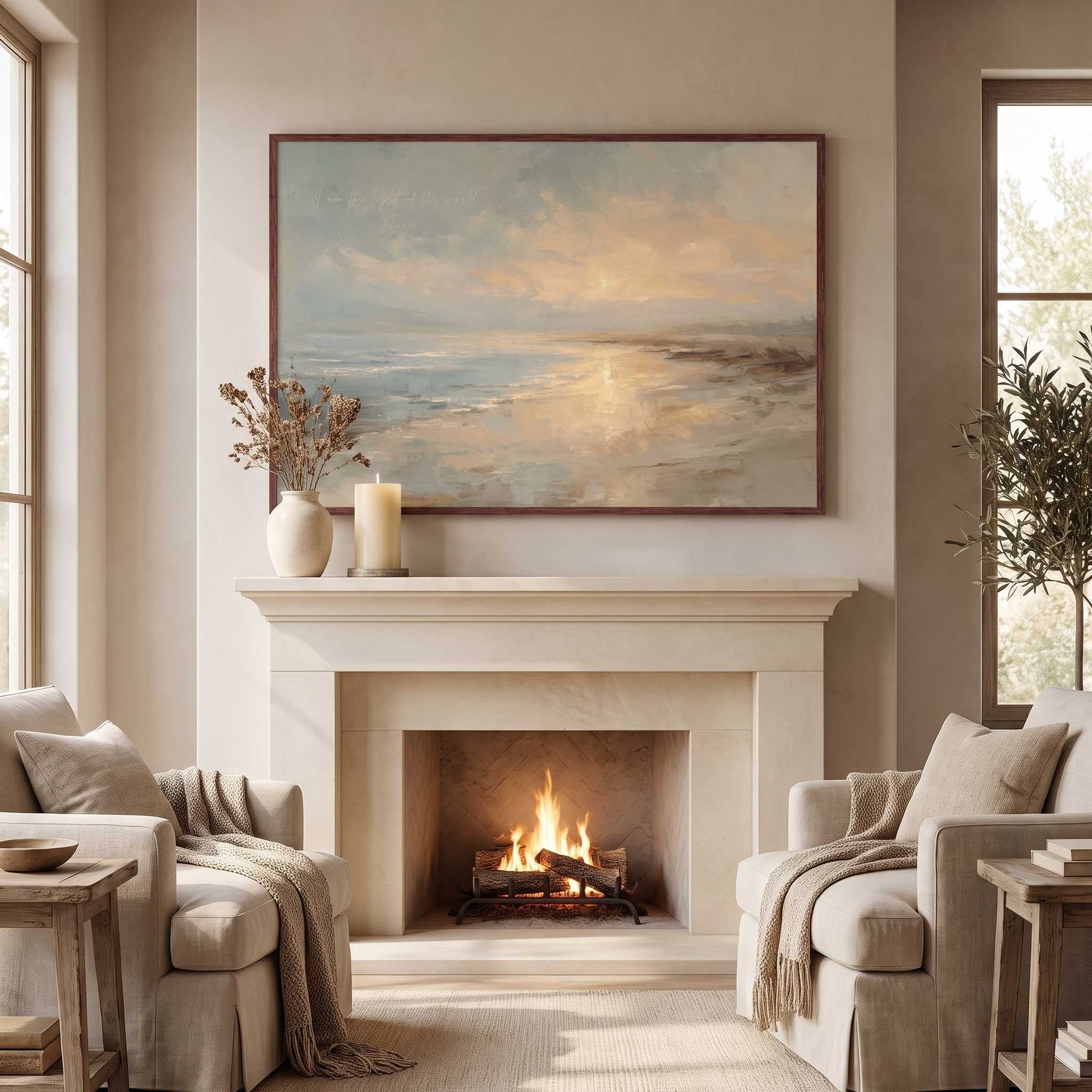 Framed vintage John 8:12 Christian landscape canvas wall art featuring a coastal sunset scene hanging above a stone fireplace mantel with beige armchairs in a cozy living room.