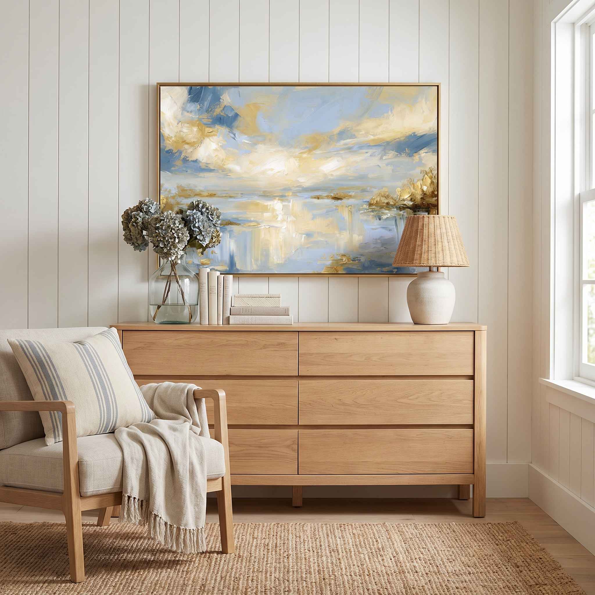 Framed abstract Psalm 36:9 Christian landscape canvas wall art featuring golden light and soft blue water hanging on a white paneled wall above a light wood dresser and beige armchair in a bright bedroom.