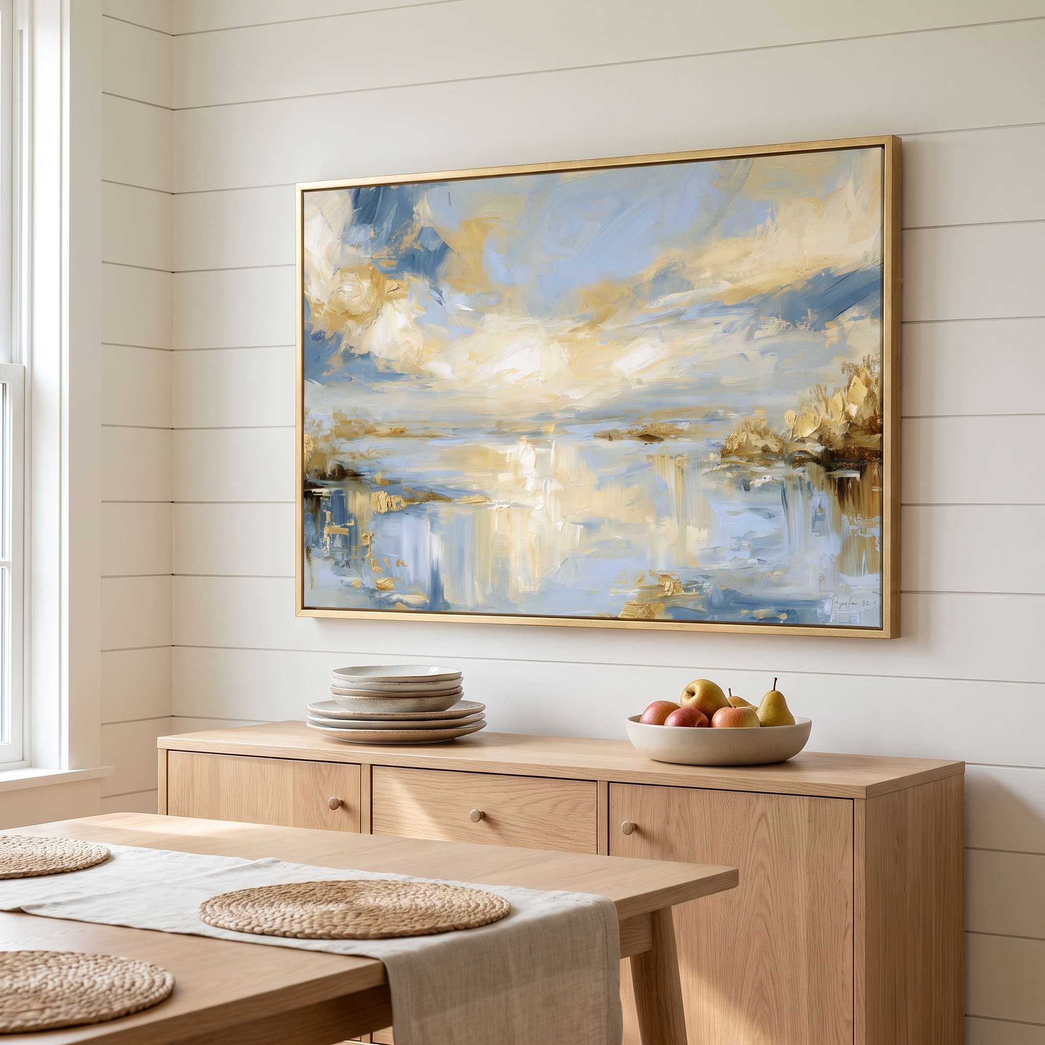Framed abstract Psalm 36:9 Christian landscape canvas wall art featuring golden light and soft blue water hanging on a shiplap wall above a light wood sideboard in a Scandinavian dining room.