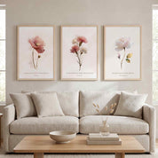 Three framed vintage Christian floral wall art prints featuring Isaiah 30:15, Psalm 103:5, and Lamentations 3:23 Scripture verses with watercolor flowers, displayed as a 3-piece triptych above a cream sofa in a soft organic modern living room.