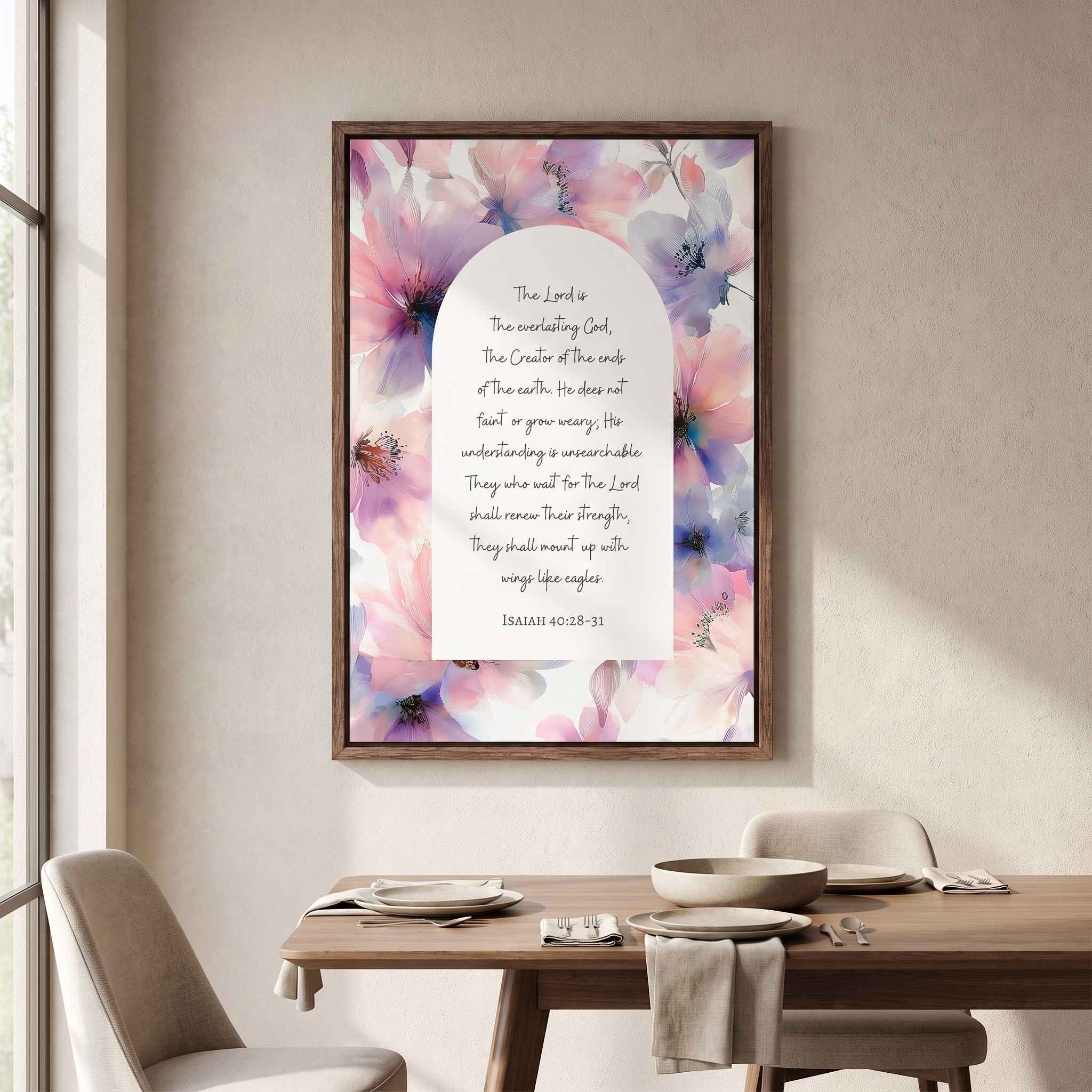 Framed vintage Christian floral wall art titled Isaiah 40:28–31 featuring "Those who hope in the Lord" with watercolor botanical artwork, displayed in a dark wood frame on a beige wall above a set dining table in a soft organic modern dining room.