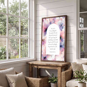 Framed vintage Christian floral wall art titled Isaiah 40:28–31 featuring "Those who hope in the Lord" with watercolor botanical artwork, displayed in a dark wood frame on a wooden console table in a bright sunroom with wicker seating.