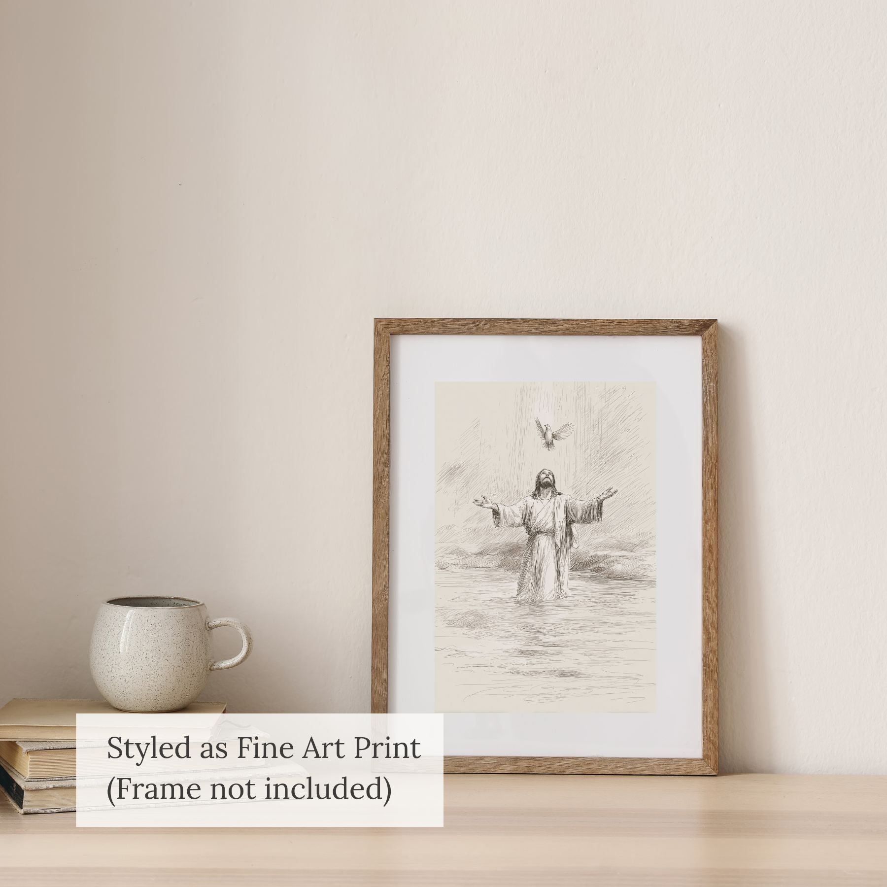 Minimalist Jesus Baptism line art sketch styled as a fine art print in a light wood frame on a table with a white ceramic mug.