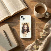 Phone case with a religious design on a wooden table with a book and coffee cup.