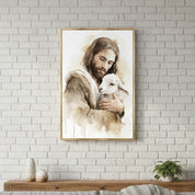 Jesus the Good Shepherd holding a lamb in a gold frame on a white brick wall above a wood console, Christian watercolor wall art inspired by John 10:11.