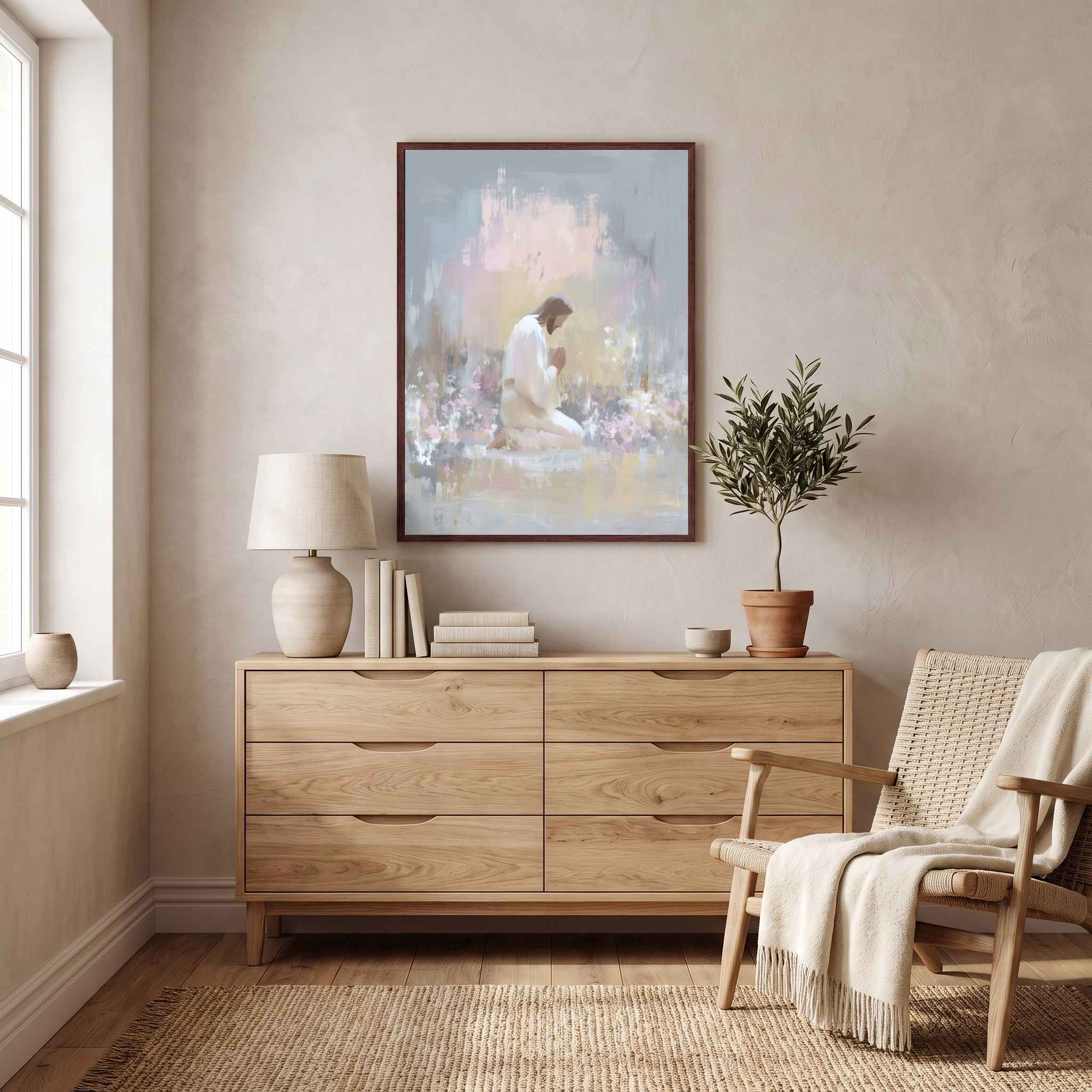 Framed Jesus praying in Gethsemane wall art above a light wood dresser in a neutral bedroom, showing Christ kneeling in a softly colored garden.