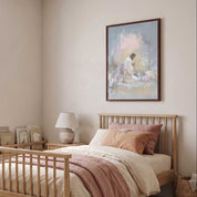 Framed Jesus praying in Gethsemane wall art above a nursery bed with blush bedding, showing Christ kneeling in a soft watercolor garden.