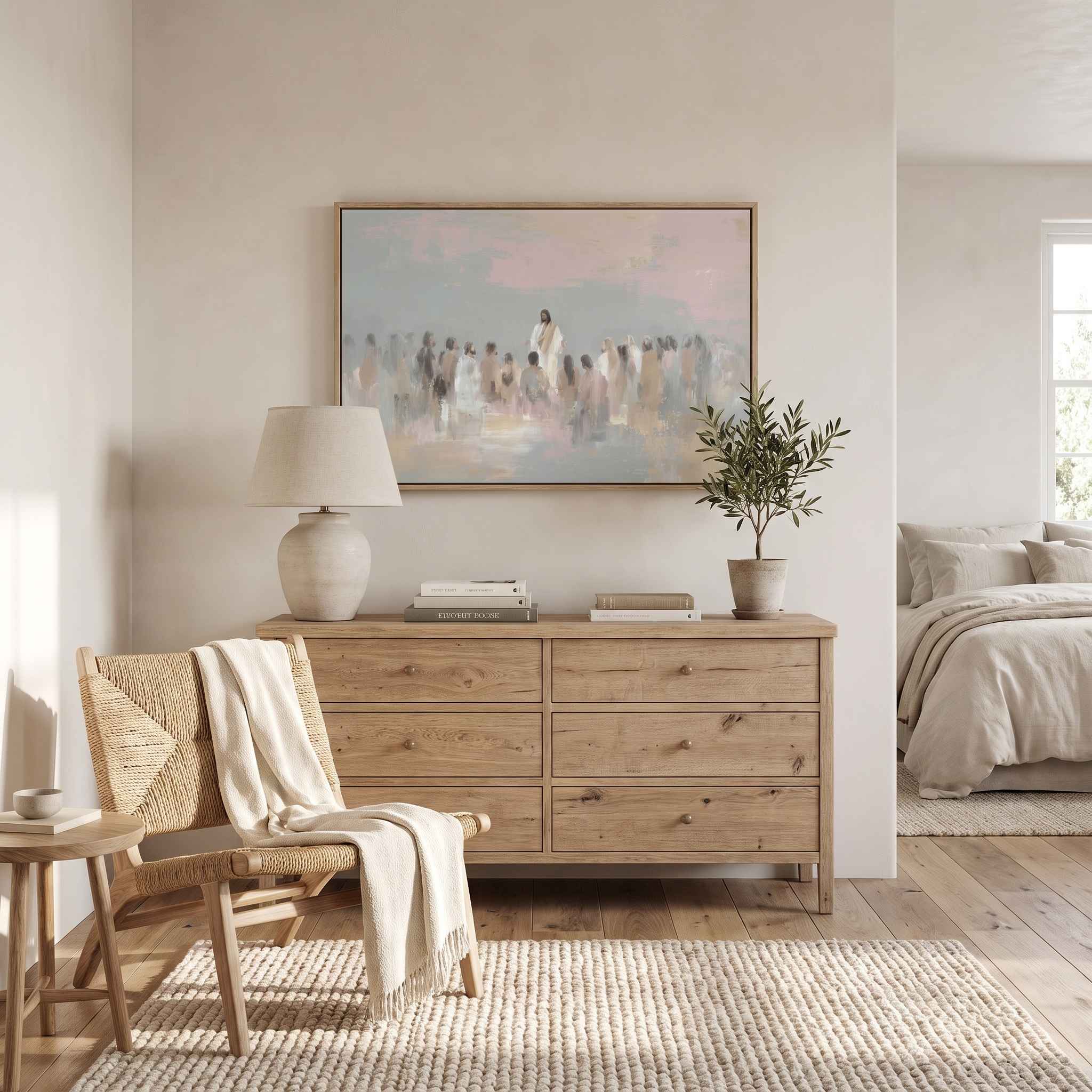 Framed Jesus teaching the people wall art above a wood dresser in a neutral bedroom, showing Christ speaking to a gathered crowd in a soft pastel watercolor.
