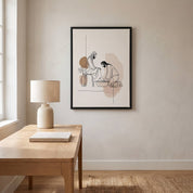 Minimalist line art print of Jesus washing feet in a black frame hanging on a light beige wall above a wooden desk with a lamp.