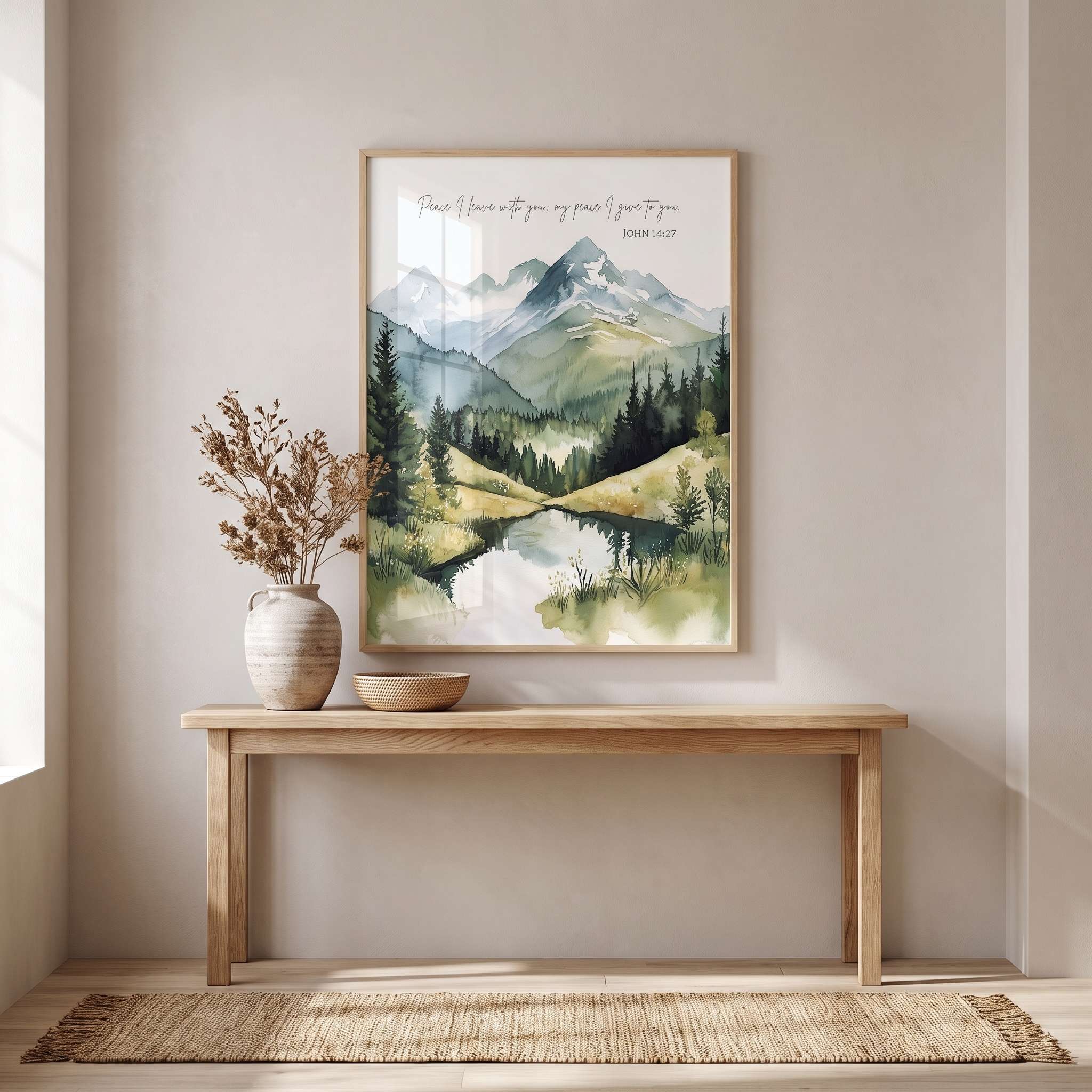 Framed John 14:27 watercolor wall art with a mountain stream and “Peace I leave with you” verse, displayed above an entryway console with a vase and bowl.