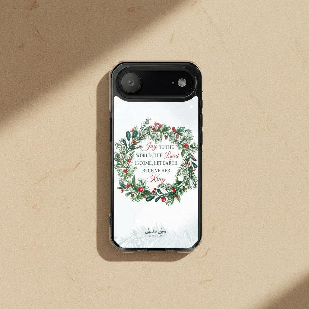 Joy to the World Christian Christmas MagSafe iPhone case with a watercolor holiday wreath on a minimalist sandstone textured background.