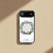 Joy to the World Christian Christmas MagSafe iPhone case with a watercolor holiday wreath on a minimalist sandstone textured background.