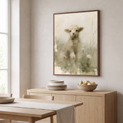 Framed lamb Christian wall art above a light wood sideboard in a bright dining room, inspired by John 10:27–28 and Jesus’ love for His sheep.