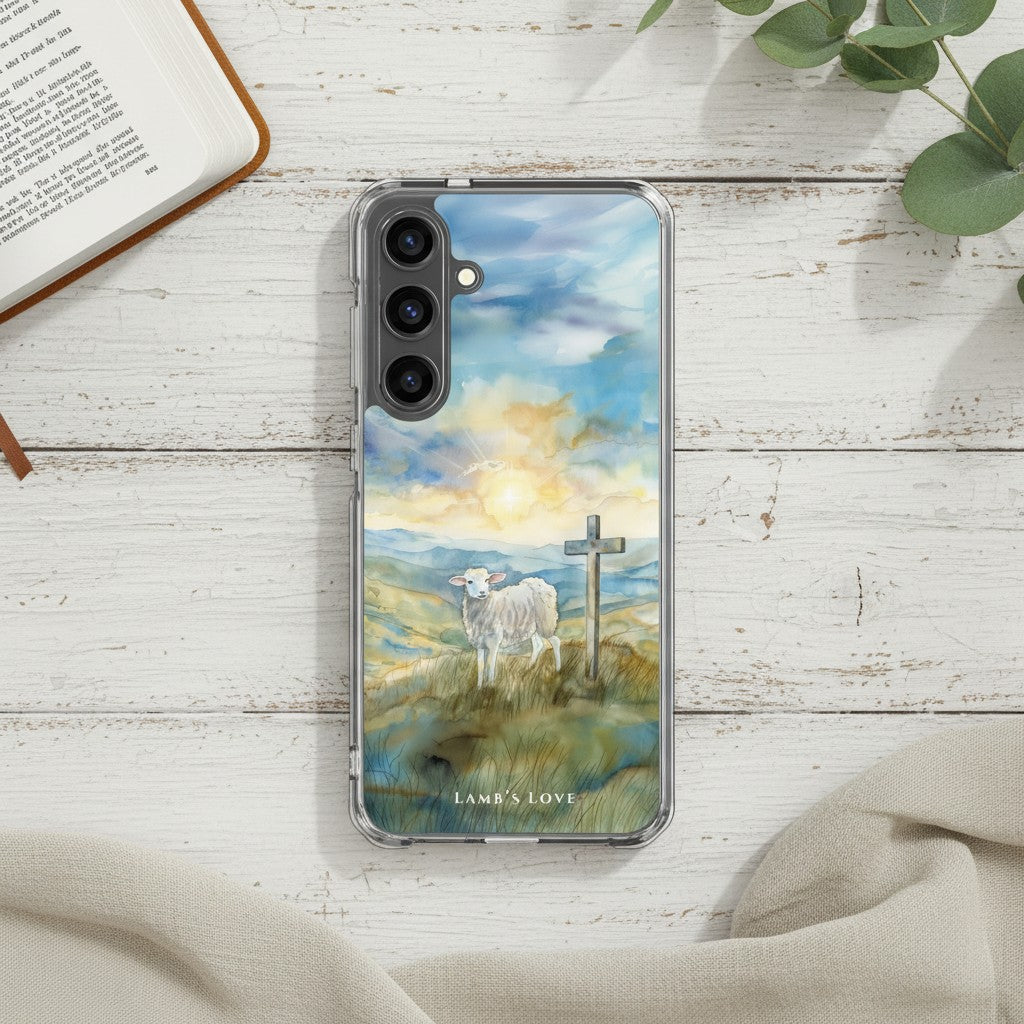 Lamb of God Samsung phone case with lamb and cross in peaceful landscape on white painted wooden table with Bible and eucalyptus leaves symbolizing Jesus who takes away the sin of the world John 1:29