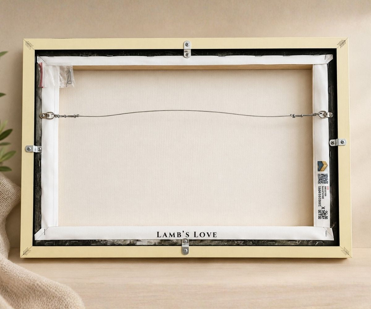 Back view of a framed Lamb's Love canvas wall art showing solid wood frame quality, hanging wire, and back backing