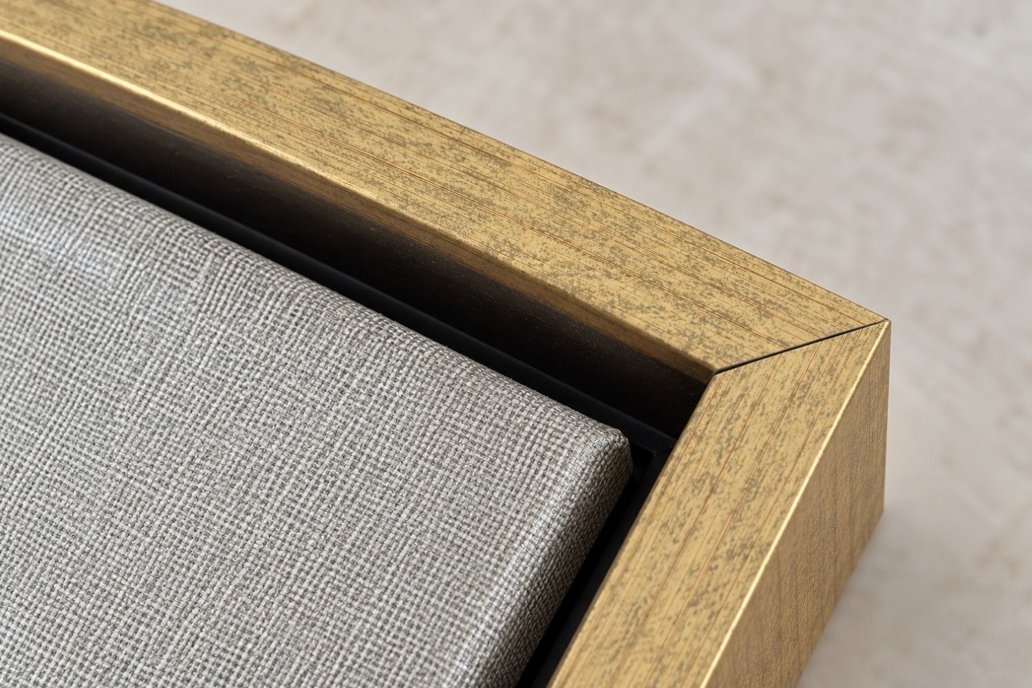 Close-up corner view of a warm gold wood frame and textured canvas print quality by Lamb's Love