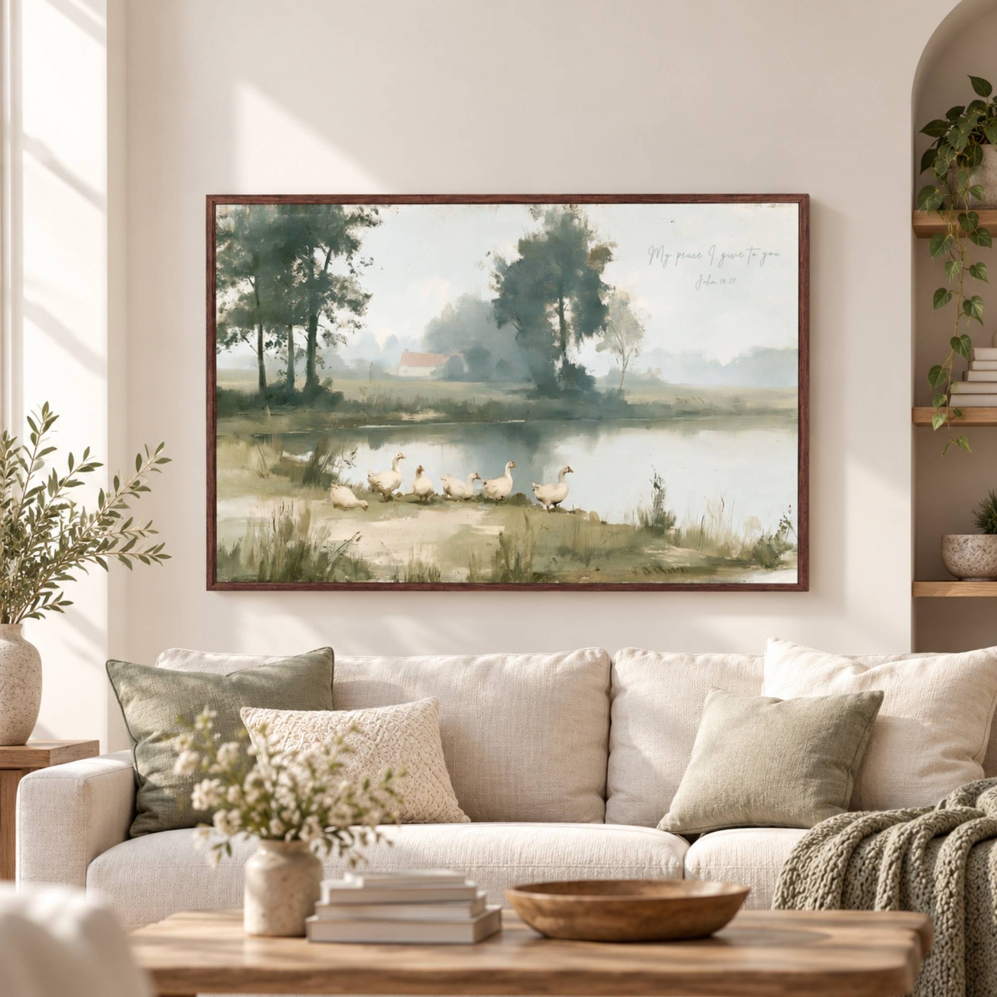Framed vintage John 14:27 landscape canvas print hanging above a beige sofa in a modern living room by Lamb's Love