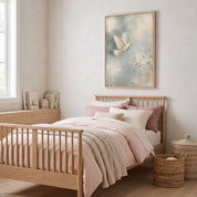 Led by the Spirit Christian dove kids wall art in a light wood frame above a wooden bed with pink and cream bedding in a softly lit child’s bedroom.