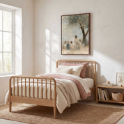 Let the Little Children Come Jesus with children Christian wall art above a wooden single bed with cream bedding and a dusty pink throw in a sunlit bedroom.
