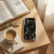 Samsung phone case with motivational quote on a desk with coffee, book, and plant