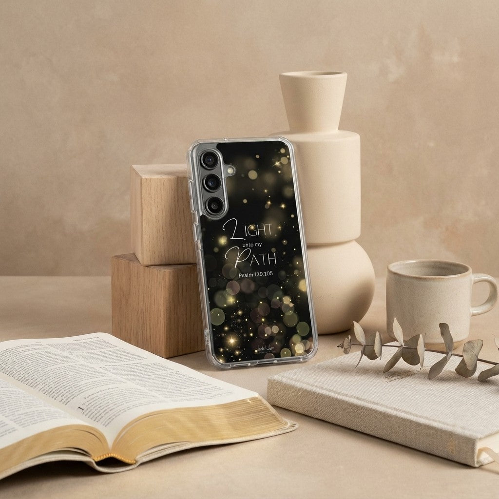 Christian Samsung case with inspirational text on a table with books and a mug