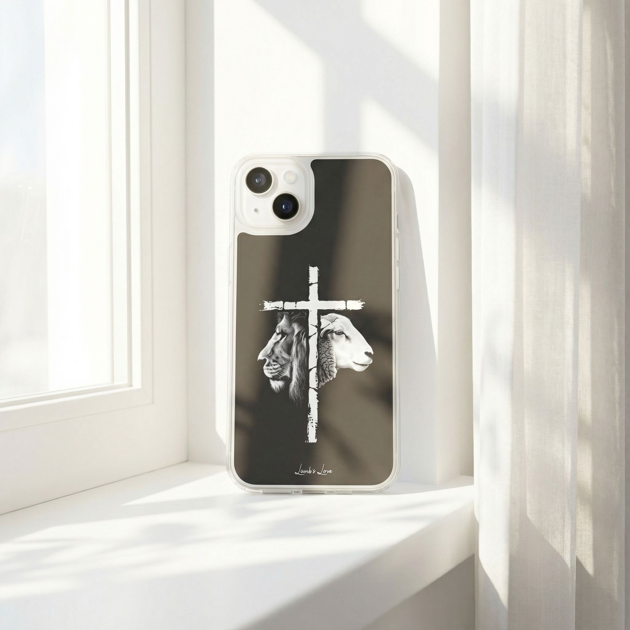 Phone case with cross and sheep design on a white surface with light streaming through a window.