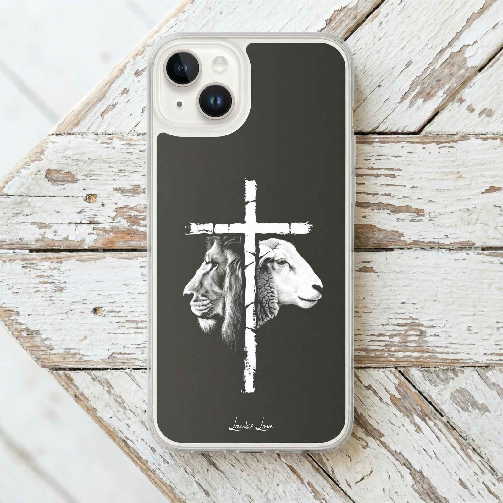 Phone case with a cross design featuring a lion and a sheep on a wooden surface