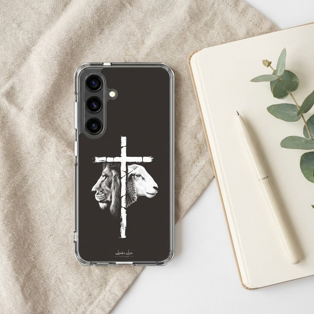 Christian Phone case with lion and lamb design on a black background, placed on a textured fabric surface with a notebook and pen.