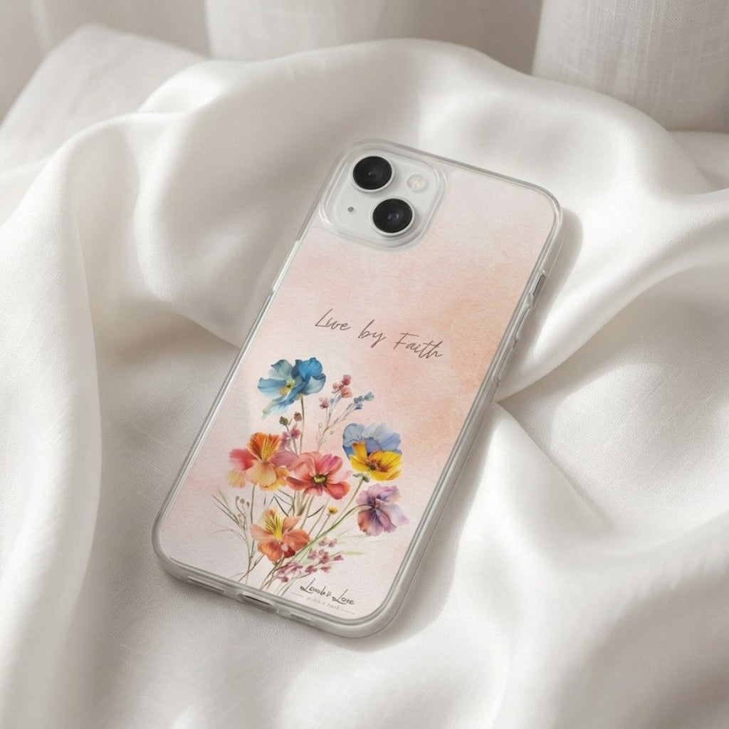 Phone case with floral design and 'Live by Faith' text on a white fabric background