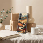 Living Water Christian Samsung Galaxy phone case inspired by John 7:37–38 with abstract river landscape design displayed on table with book, coffee cup, and decor