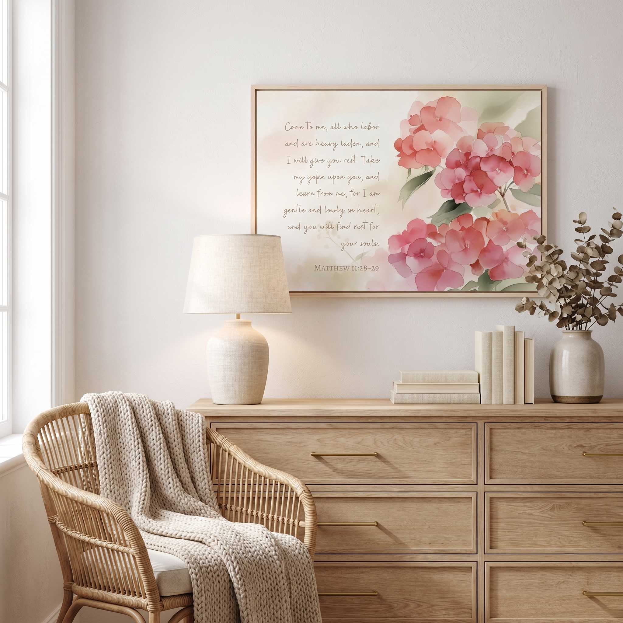 Framed Matthew 11:28 watercolor hydrangea scripture wall art displayed above a dresser in a softly styled bedroom.