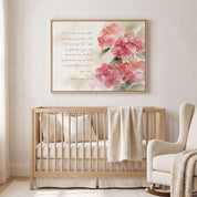 Framed Matthew 11:28 Bible verse wall art with pink hydrangeas above a light wood crib in a soft neutral nursery.