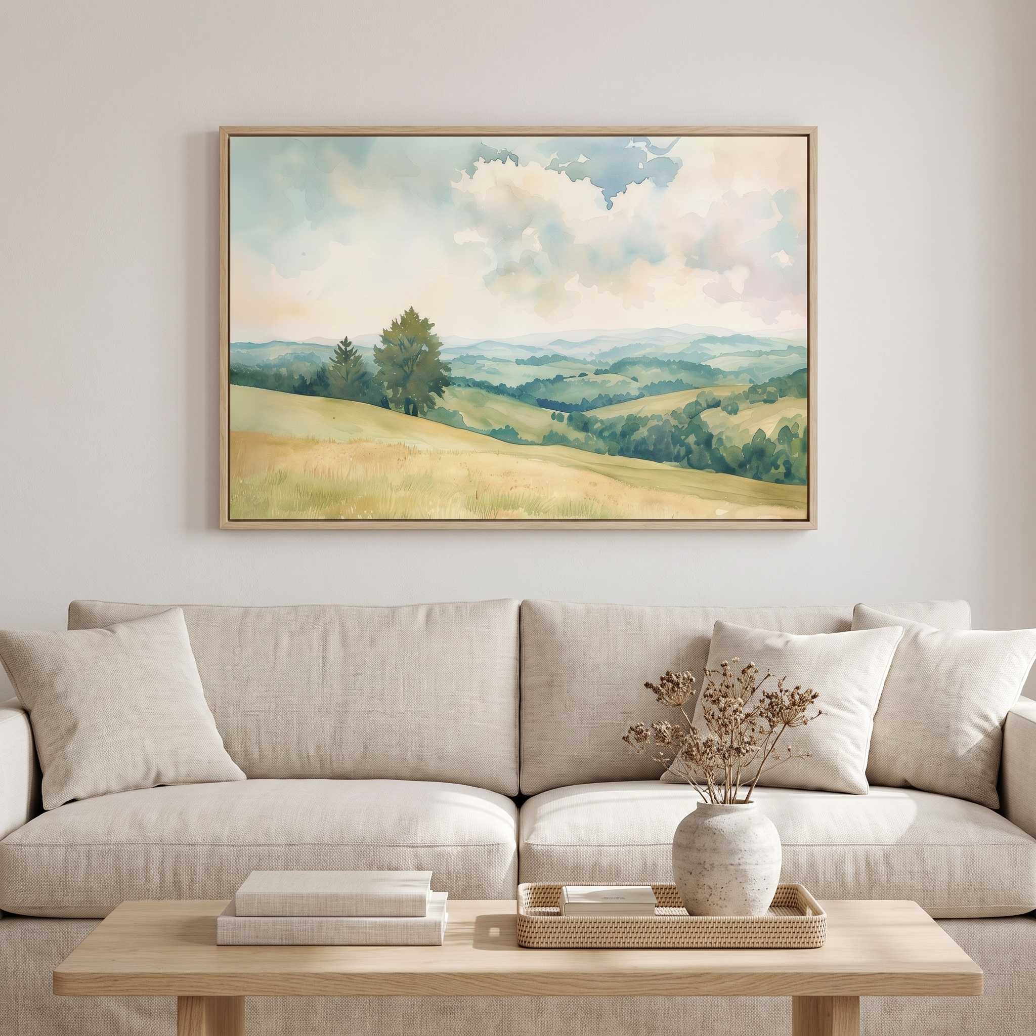 Matthew 5:9 Blessed Are the Peacemakers watercolor wall art of rolling green hills, displayed above a beige sofa in a calm neutral living room.