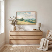 Matthew 5:9 Blessed Are the Peacemakers Christian landscape wall art in a light wood frame above a dresser in a bright neutral bedroom.