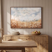 Matthew 6:28 wildflower Bible verse wall art displayed above a wooden sideboard in a dining room, with a peaceful field of white flowers.
