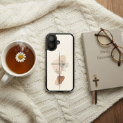 Minimalist cross and lily Christian MagSafe iPhone case beside devotional book and tea on cozy knitted blanket with warm neutral faith-inspired aesthetic