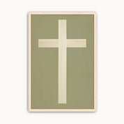 Minimalist cross wall art featuring an elegant ivory cross on a soft sage green background with a light wood frame for modern Christian home decor.