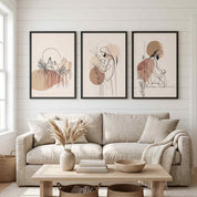 Minimalist Jesus 3-piece framed canvas wall art triptych set displayed on a white paneled wall above a beige sofa in an organic modern living room.