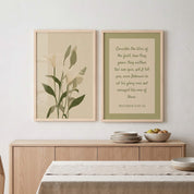 Minimalist Matthew 6:28–29 Scripture and calla lily 2-piece framed poster Christian wall art set displayed on a neutral paneled wall above a light wood sideboard in an organic modern dining room.