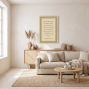 Minimalist Matthew 6:28–29 Scripture vertical framed canvas Christian wall art in soft sage green displayed on a neutral wall above a light wood sideboard in an organic modern living room.