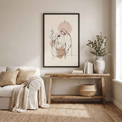 Minimalist line art print of the Nativity scene framed in black hanging above a wooden console table decorated with a wooden manger set and candles.