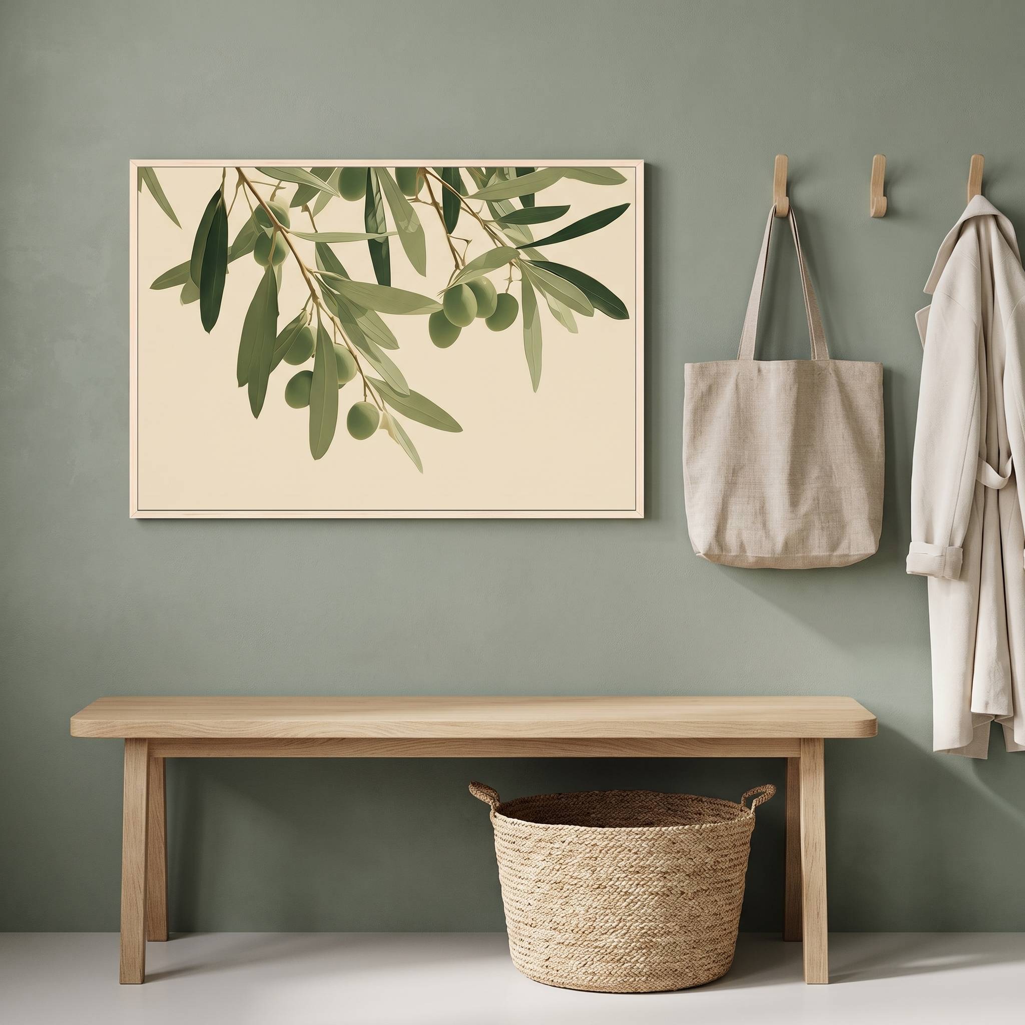 Minimalist olive branch horizontal framed canvas artwork displayed above a light wood bench in a sage green organic modern entryway with wall hooks and a woven basket.