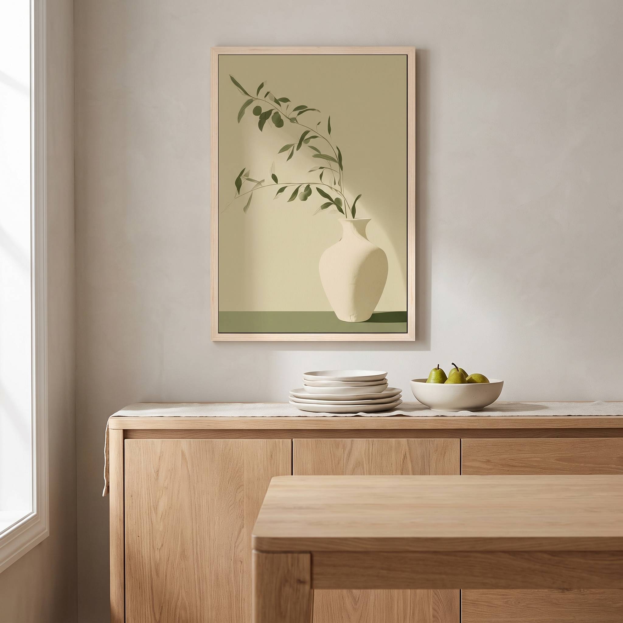 Minimalist olive branch in a white ceramic vase vertical framed canvas Christian wall art in soft sage green displayed on a light gray wall above a wooden sideboard in an organic modern dining room.