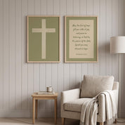 Minimalist Romans 15:13 Scripture and ivory cross 2-piece framed poster wall art set displayed on a vertical paneled wall above a beige armchair in an organic modern reading nook.