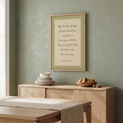 Minimalist Romans 15:13 Scripture vertical framed canvas wall art in soft sage green displayed on a textured plaster wall above a light wood sideboard in an organic modern dining room.